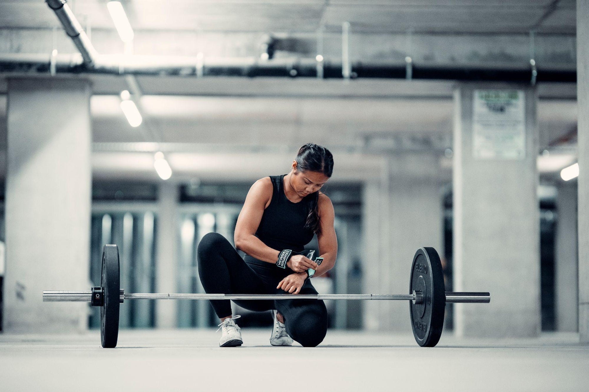 Female weightlifter using her Versa Gripps to help her grip fatigue