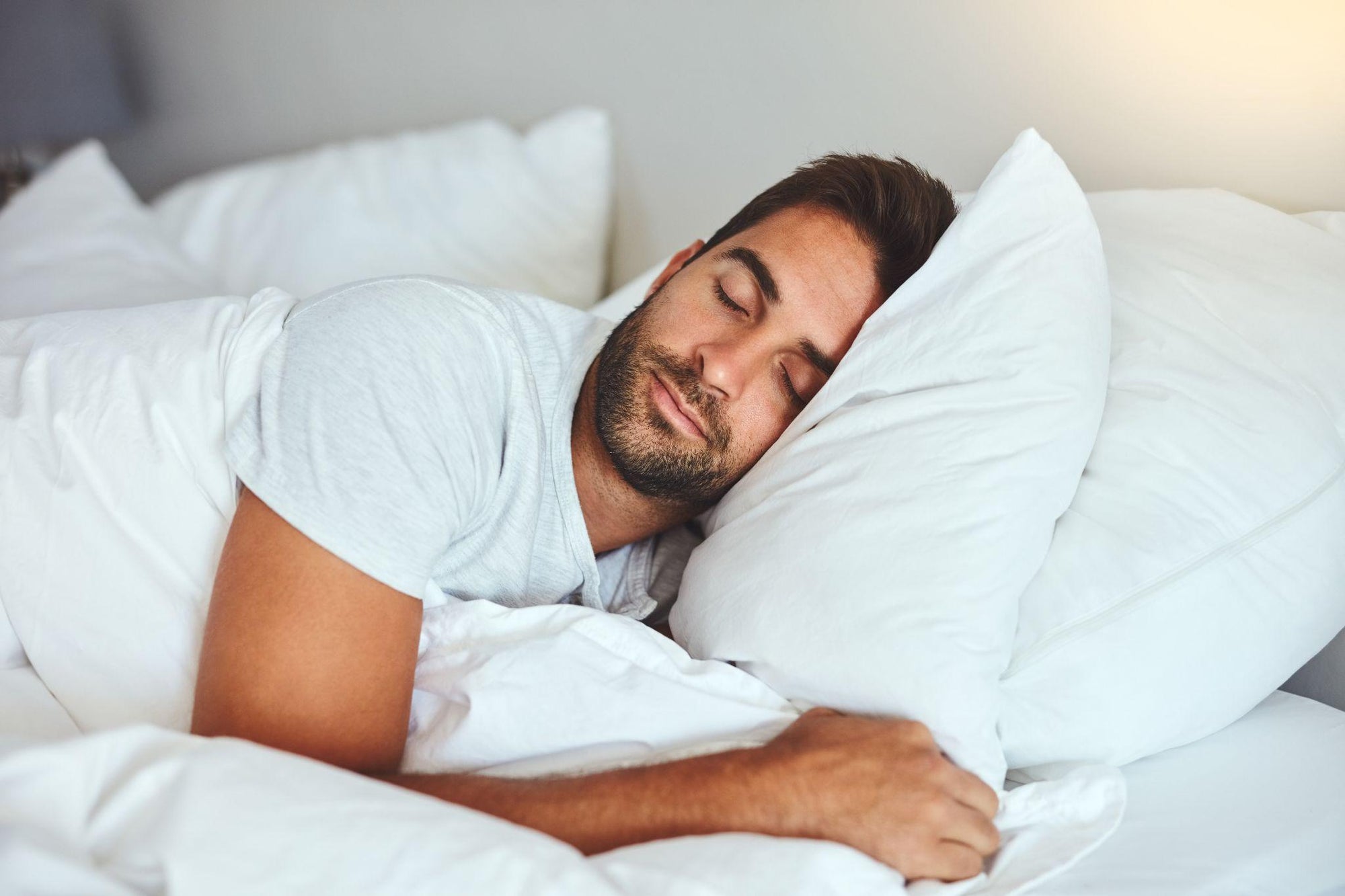 Man sleeping peacefully in bed after a workout